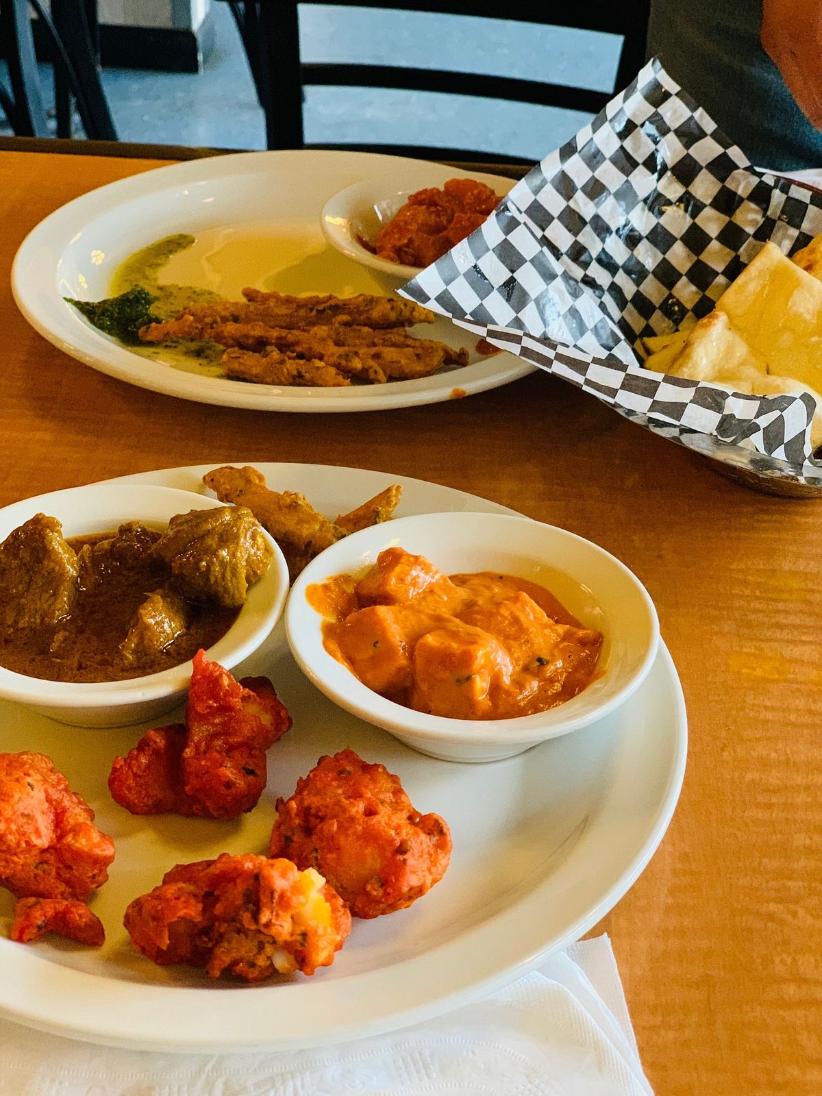 A platter of curries, tandoori pieces and naan