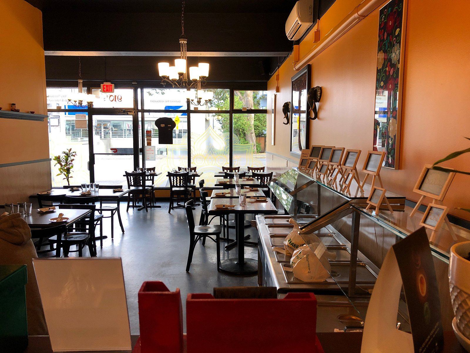 The dining room on Esquimalt Road with warm orange walls and the front counter