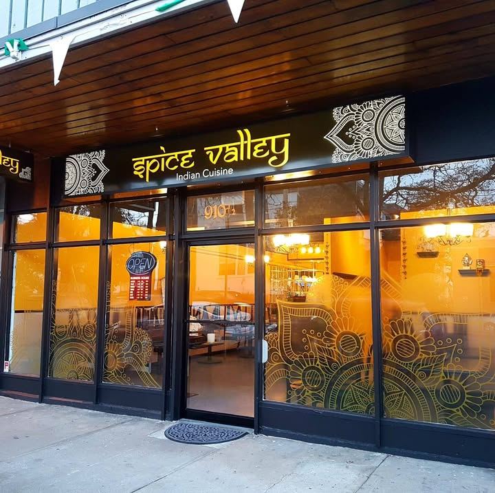 Spice Valley Indian Cuisine storefront on Esquimalt Road, lit up at dusk
